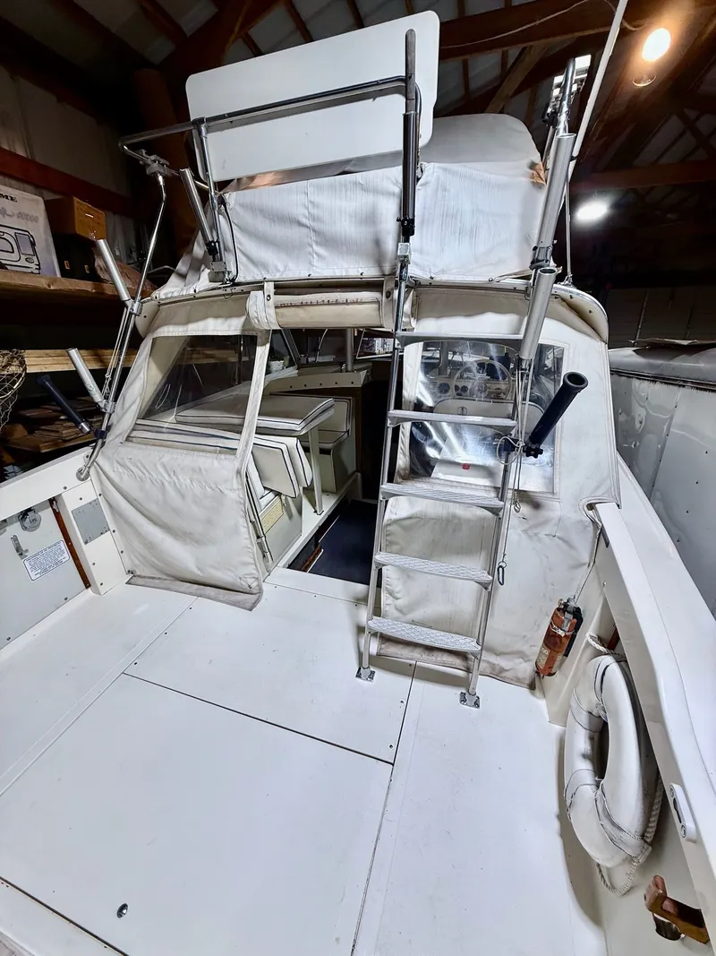Slide: The Image of 1973 Bertram Sport Fisherman boat interior with ladder and seating area. - 2
