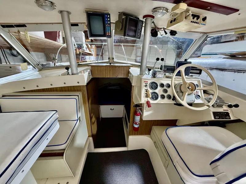 Slide: The Image of 1973 Bertram Sport Fisherman boat interior with steering wheel, gauges, and navigation equipment. - 4