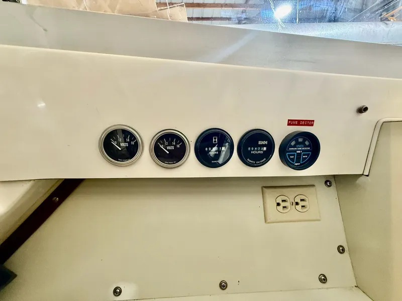 Slide: The Image of 1973 Bertram Sport Fisherman dashboard with voltmeters, hour meters, and fume detector. - 7