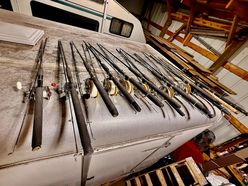 Slide: The Image of Fishing rods lined up on a 1973 Bertram Sport Fisherman boat in a storage area. - 8