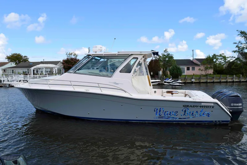 The Image of 2012 Grady-White Express 360 boat on water, side view with Yamaha engines. - 0