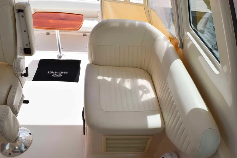 Slide: The Image of 2012 Grady-White Express 360 interior with cream seating and wooden table. - 17