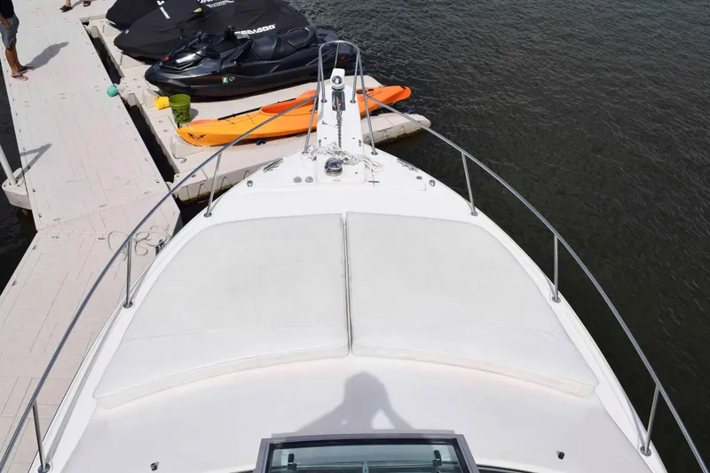 Slide: The Image of Bow view of 2012 Grady-White Express 360 docked with jet skis nearby. - 18