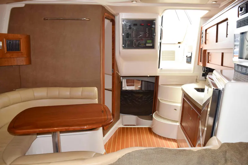 Slide: The Image of Interior of 2012 Grady-White Express 360 boat with seating, table, and kitchenette. - 27