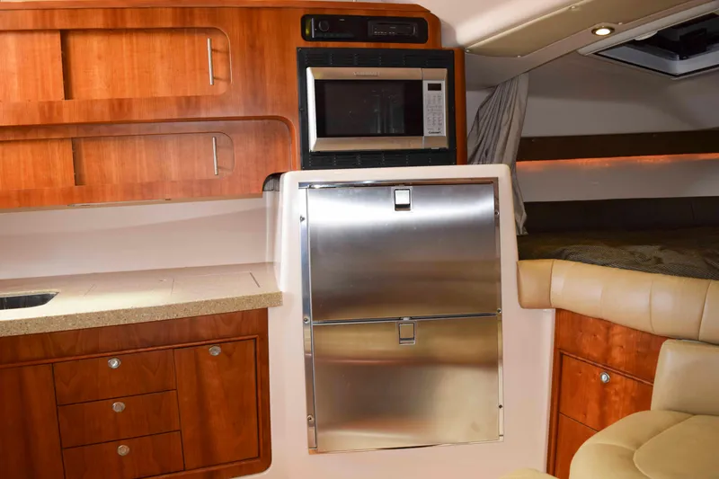 Slide: The Image of 2012 Grady-White Express 360 interior with wood cabinetry and stainless steel appliances. - 38