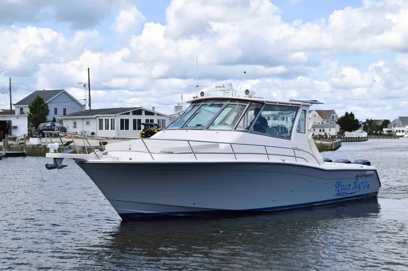 Slide: The Image of 2012 Grady-White Express 360 boat on water, with coastal houses in the background. - 4