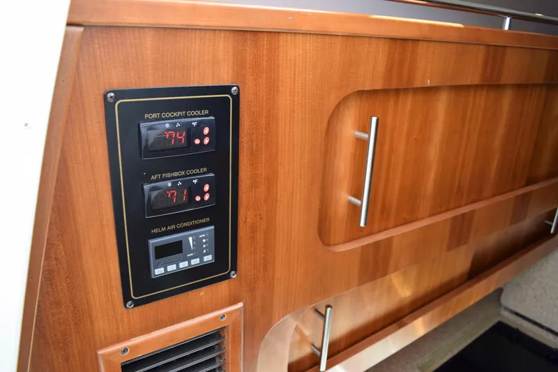 Slide: The Image of 2012 Grady-White Express 360 interior with temperature controls and wooden cabinetry. - 41