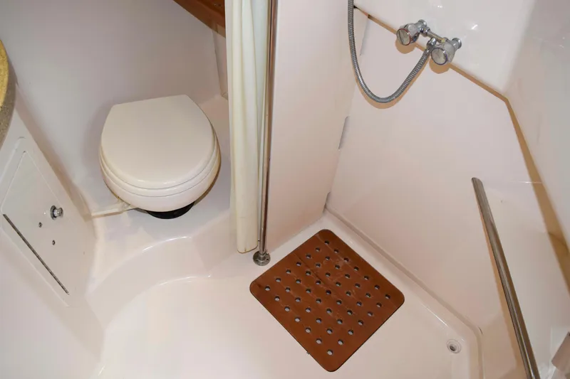 Slide: The Image of Bathroom interior of 2012 Grady-White Express 360 boat, featuring toilet and shower area. - 42