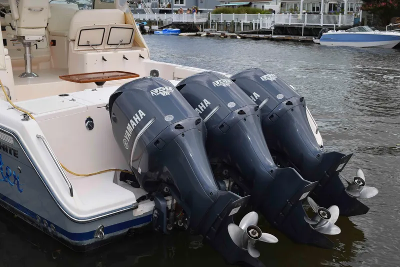 Slide: The Image of 2012 Grady-White Express 360 with triple Yamaha outboard engines docked by waterfront homes. - 43