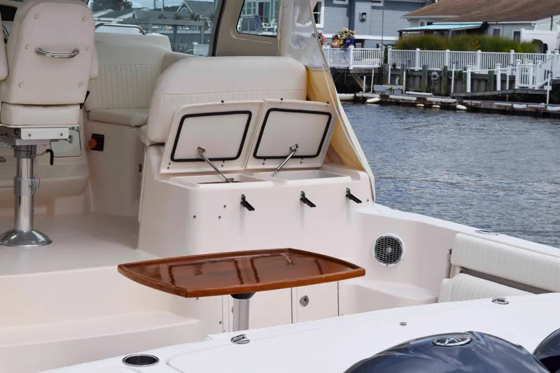 Slide: The Image of 2012 Grady-White Express 360 boat interior with seating and storage, dockside view. - 8