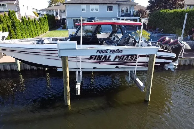 Slide: The Image of 2023 Fountain 38 SCX boat docked in a residential canal setting. - 10