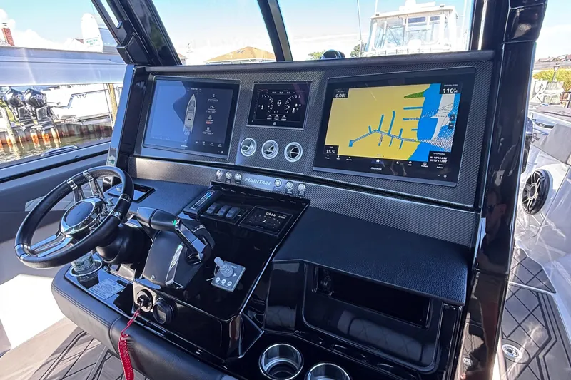 Slide: The Image of 2023 Fountain 38 SCX boat docked, aerial view, sleek design, modern seating. - 15