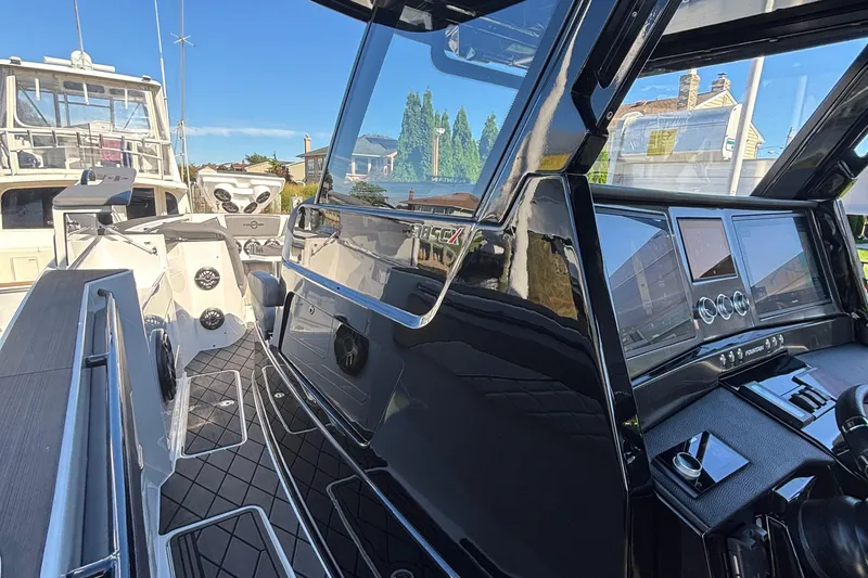 Slide: The Image of 2023 Fountain 38 SCX boat interior with modern dashboard and seating. - 17