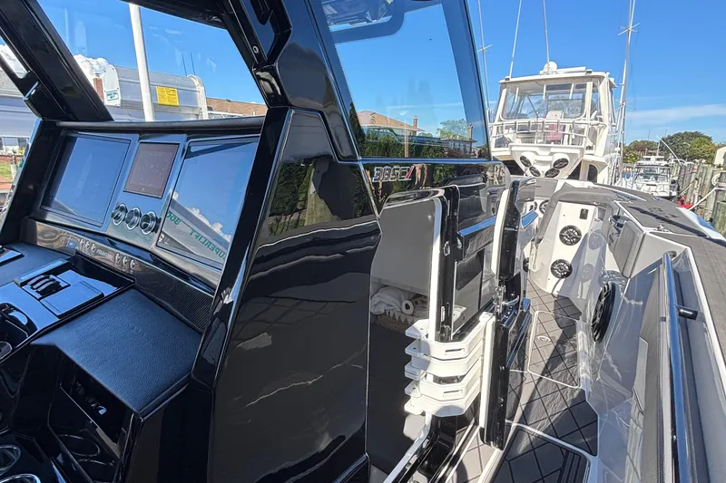 Slide: The Image of 2023 Fountain 38 SCX boat on trailer, sleek design, parked among other boats. - 18