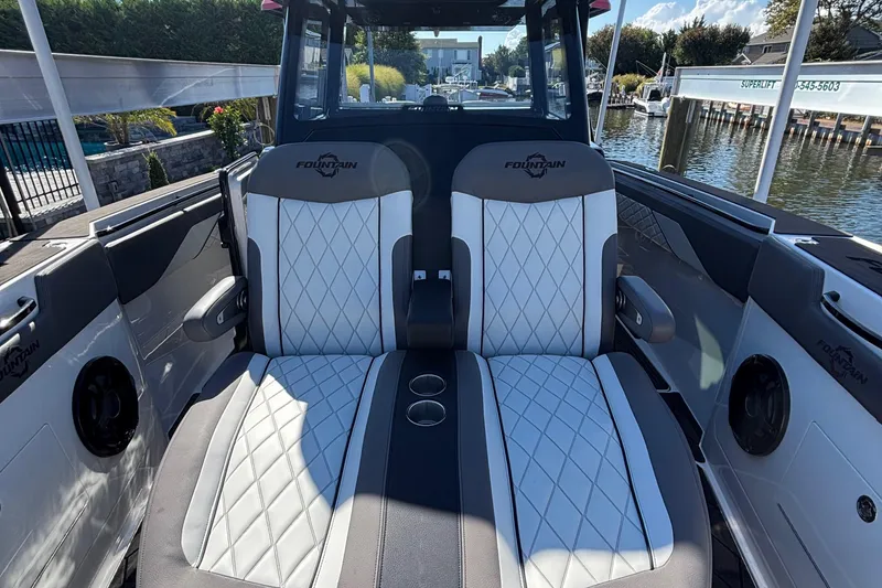 Slide: The Image of 2023 Fountain 38 SCX boat docked, featuring sleek design and powerful Mercury engines. - 19