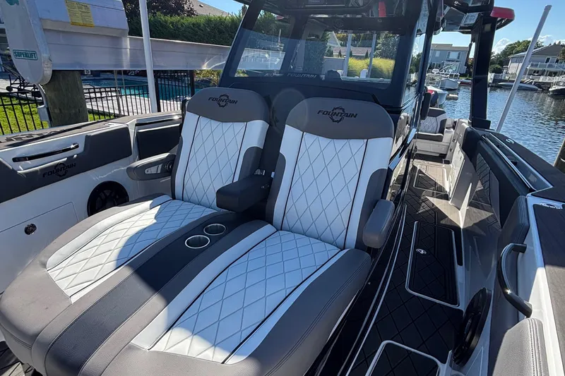 Slide: The Image of 2023 Fountain 38 SCX boat with luxurious seating near a poolside setting. - 21
