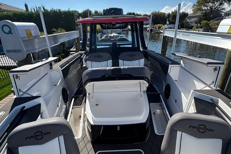 Slide: The Image of 2023 Fountain 38 SCX boat docked near a poolside patio. - 22