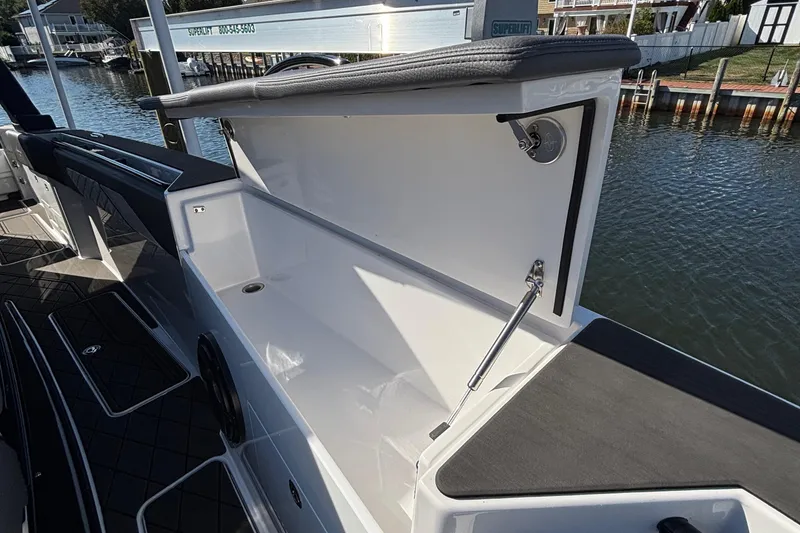 Slide: The Image of 2023 Fountain 38 SCX boat with triple 400R engines docked near a house. - 23