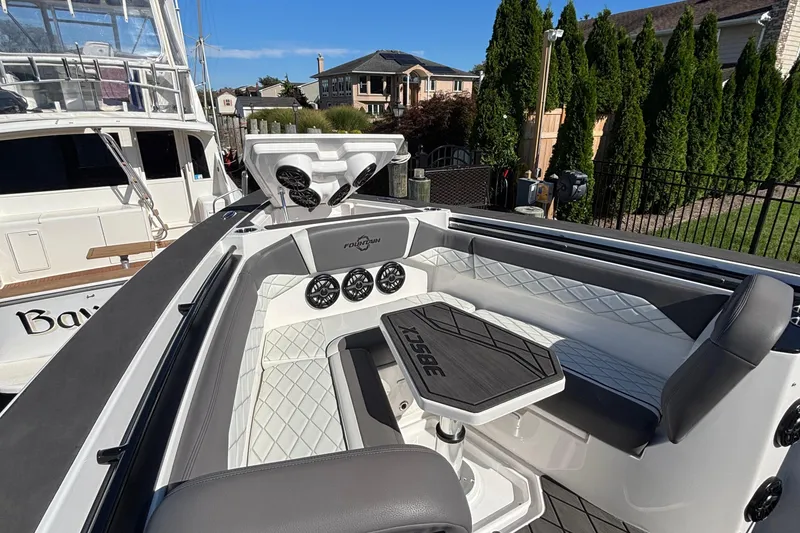 Slide: The Image of 2023 Fountain 38 SCX boat dashboard with navigation screens and steering wheel. - 25