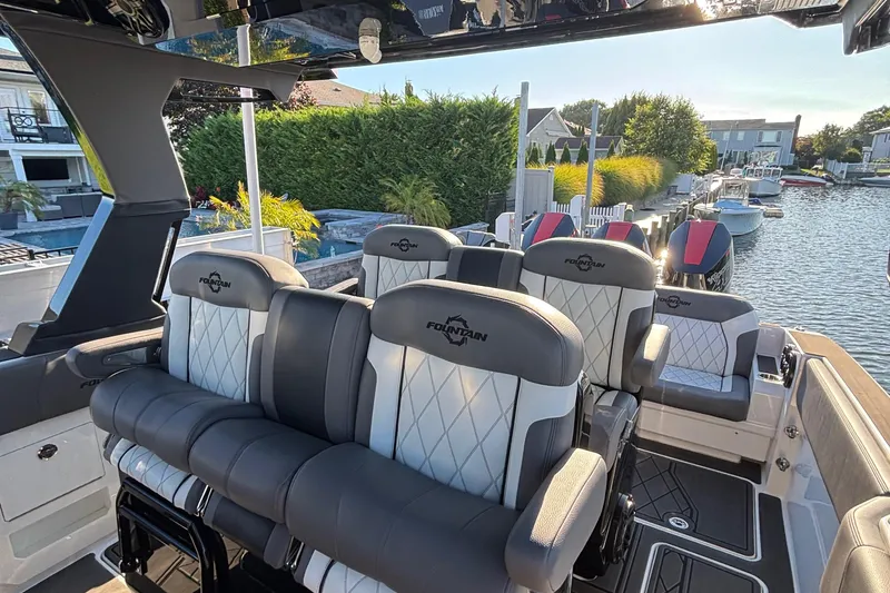 Slide: The Image of 2023 Fountain 38 SCX boat interior with luxurious seating and cup holders. - 30