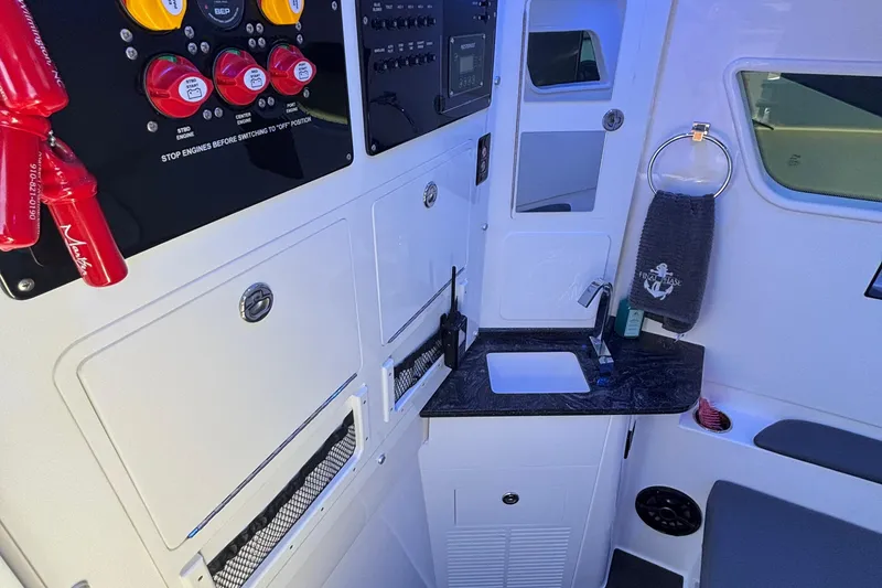 Slide: The Image of 2023 Fountain 38 SCX boat seat with diamond stitching, speakers, and cup holder by the water. - 38