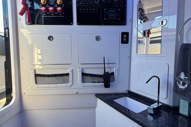 Slide: The Image of 2023 Fountain 38 SCX boat interior with white and gray seating and storage compartment. - 39