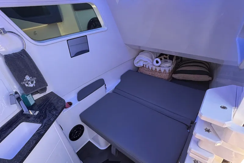 Slide: The Image of 2023 Fountain 38 SCX boat interior with luxurious seating and scenic waterfront view. - 40