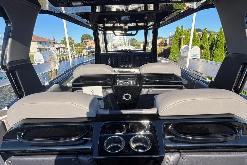Slide: The Image of 2023 Fountain 38 SCX boat interior with luxurious seating and scenic waterfront view. - 41