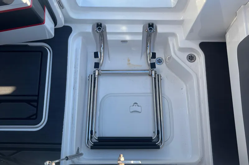 Slide: The Image of 2023 Fountain 38 SCX boat interior with open door, black and red accents. - 47