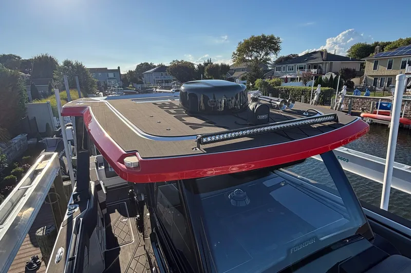 Slide: The Image of 2023 Fountain 38 SCX boat interior with control panel, sink, and storage compartments. - 50