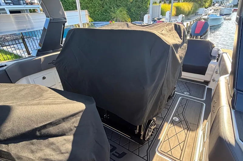 Slide: The Image of 2023 Fountain 38 SCX boat storage compartments with open doors, showcasing interior space. - 56