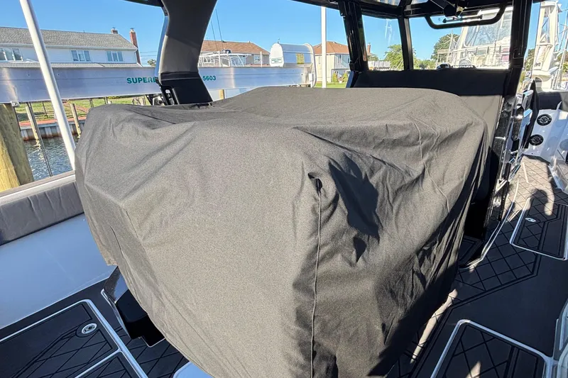 Slide: The Image of 2023 Fountain 38 SCX boat interior with cushioned seating and storage compartment. - 57