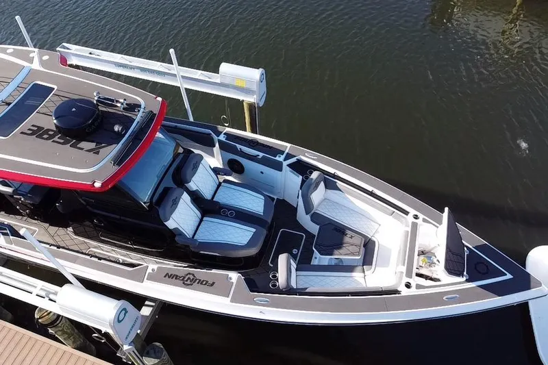 Slide: The Image of 2023 Fountain 38 SCX boat with triple outboard engines, sleek design, and modern seating. - 6