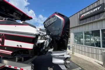 Slide: The Image of 2023 Fountain 38 SCX boat with black cover docked near luxury homes. - 63