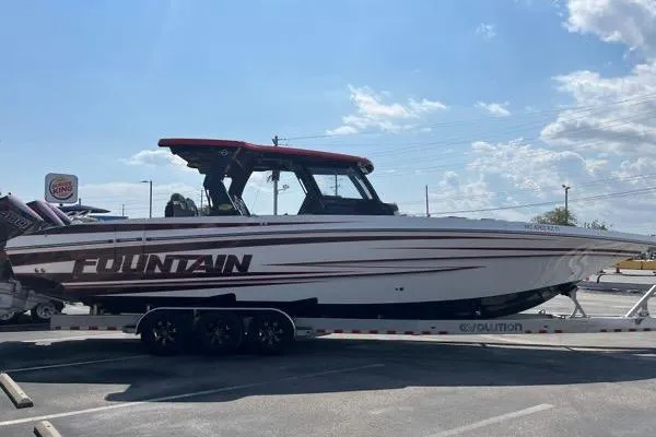 Slide: The Image of 2023 Fountain 38 SCX boat deck with speakers, sunlight reflecting on surface. - 65