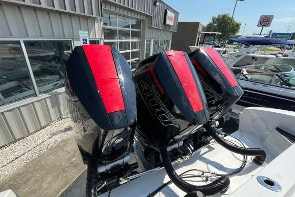 Slide: The Image of 2023 Fountain 38 SCX boat interior with covered console, docked in a marina. - 66