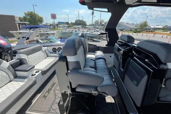 Slide: The Image of 2023 Fountain 38 SCX boat with triple engines docked in a scenic marina. - 69