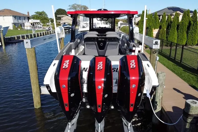 Slide: The Image of 2023 Fountain 38 SCX speedboat with sleek design, parked on a trailer in a marina. - 7