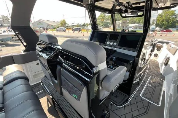 Slide: The Image of 2023 Fountain 38 SCX boat with covered outboard motors docked by waterfront homes. - 70