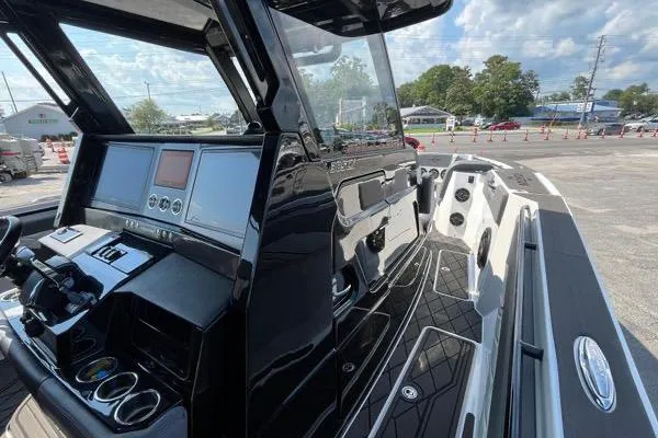 Slide: The Image of 2023 Fountain 38 SCX boat interior with luxury seating and modern dashboard. - 74