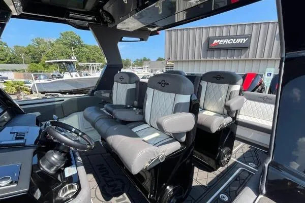 Slide: The Image of 2023 Fountain 38 SCX boat interior with luxury seating and Mercury signage. - 84