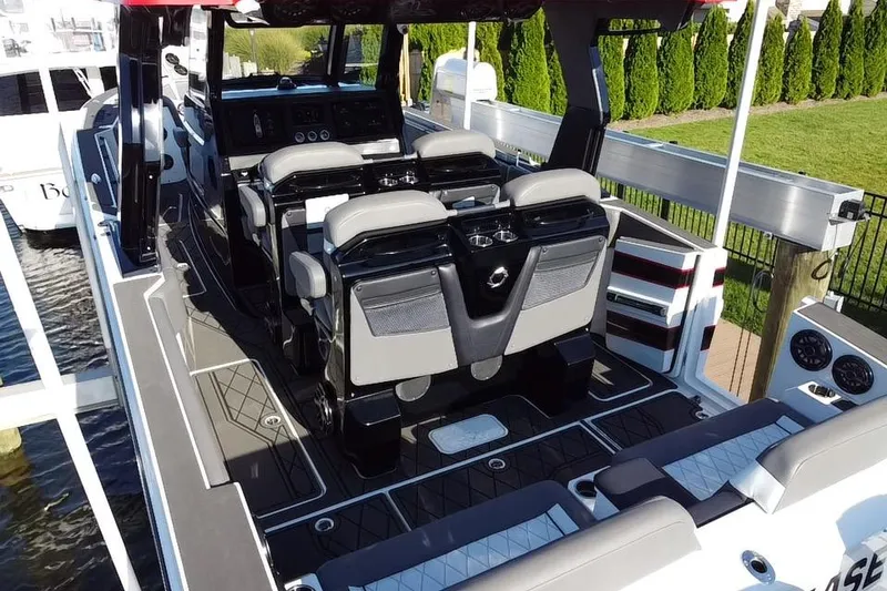 Slide: The Image of Aerial view of 2023 Fountain 38 SCX boat docked, showcasing sleek design and triple engines. - 9