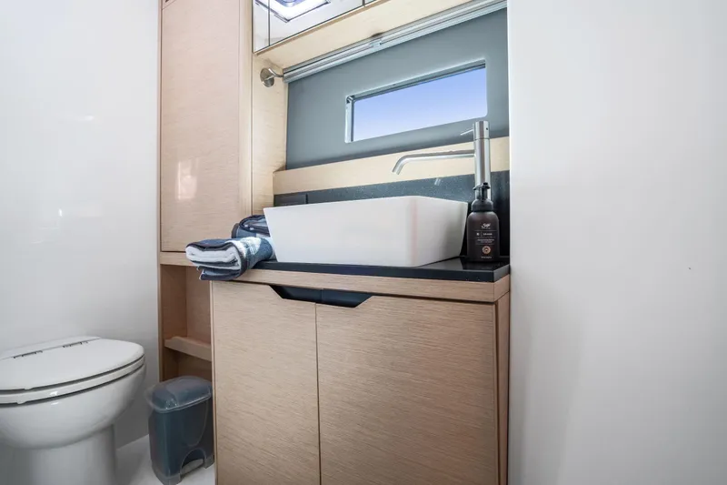 Slide: The Image of Modern bathroom interior on 2019 Itacatamarans 14.99 yacht, featuring sleek design and wooden accents. - 104