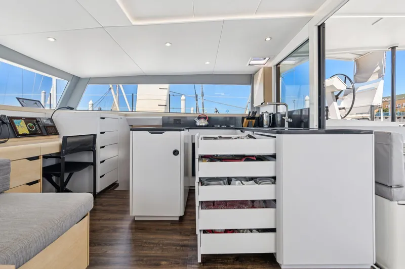 Slide: The Image of 2019 Itacatamarans 14.99 interior hallway with open floor hatch, modern design. - 107