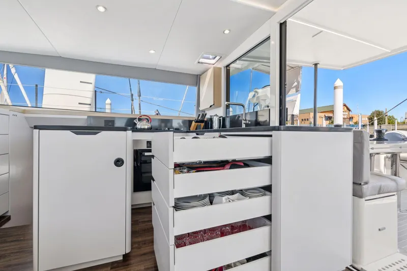 Slide: The Image of Engine compartment of 2019 Itacatamarans 14.99 with visible plumbing and pump system. - 108