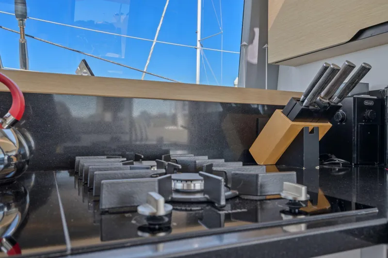 Slide: The Image of Cabin storage on 2019 Itacatamarans 14.99 with clothes and fire extinguisher. - 115