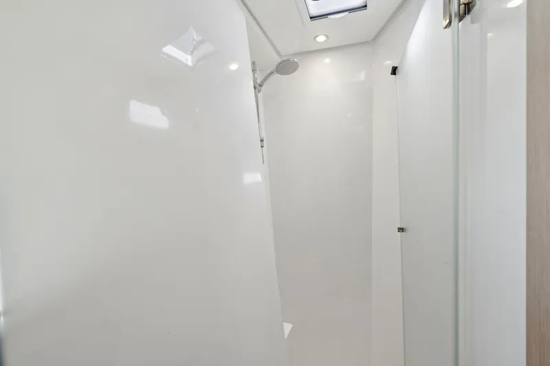 Slide: The Image of Interior cabin of 2019 Itacatamarans 14.99 with modern design and striped bedding. - 126