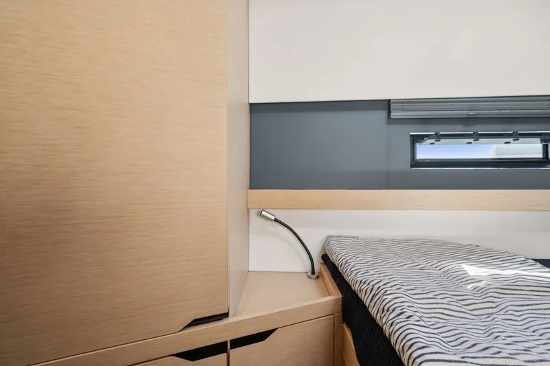 Slide: The Image of 2019 Itacatamarans 14.99 docked at marina with clear blue sky. - 135