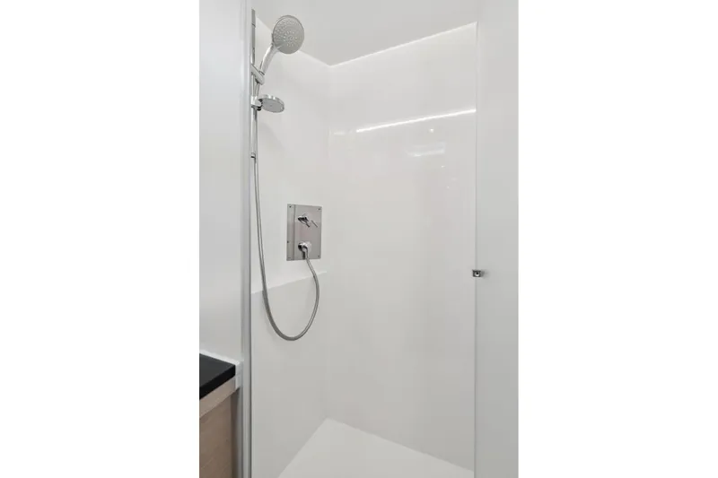 Slide: The Image of 2019 Itacatamarans 14.99 catamaran docked at marina under clear blue sky. - 137