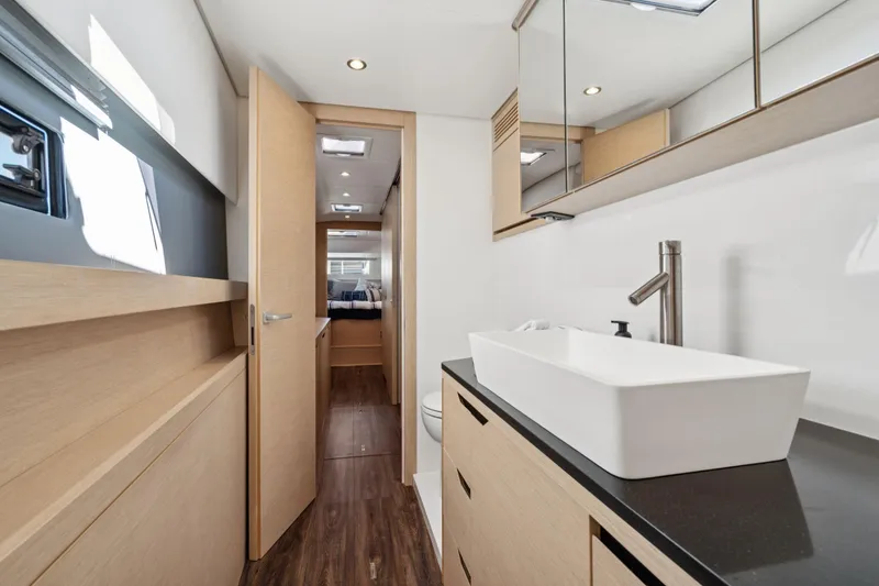 Slide: The Image of 2019 Itacatamarans 14.99 catamaran docked at marina under clear blue sky. - 145